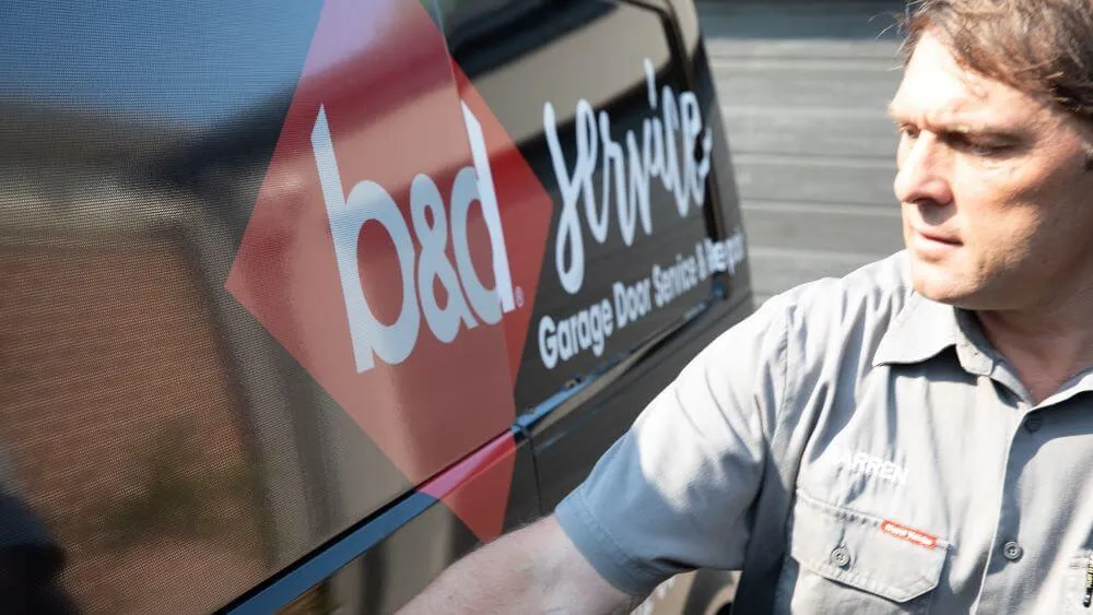 A garage door technican opening the door f a B&D repair van 