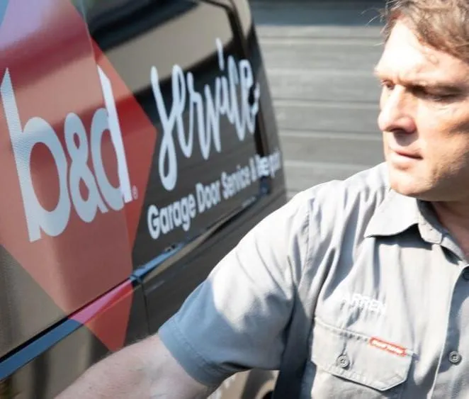 A garage door technican opening the door f a B&D repair van 