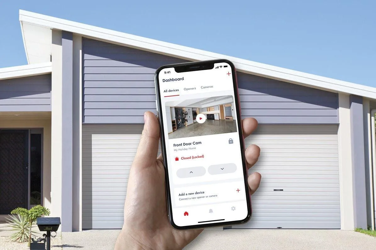 a person holding a phone in front of  a garage door 