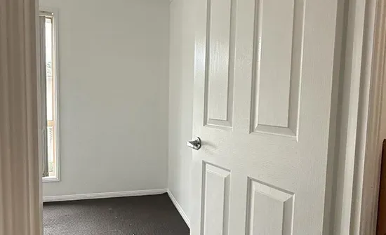 Glossy repainted internal door highlighting interior house painting detail in Brisbane