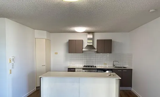 Updated kitchen walls and cabinetry following interior house painting in a Brisbane home