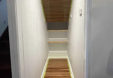 Bright white hallway with timber flooring after interior house painting in Ormiston