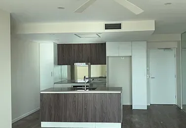 Open-plan kitchen and living area with clean white walls after interior house painting in Mount Gravatt
