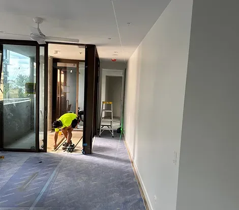 Professional painter at work on interior house painting inside a Brisbane home