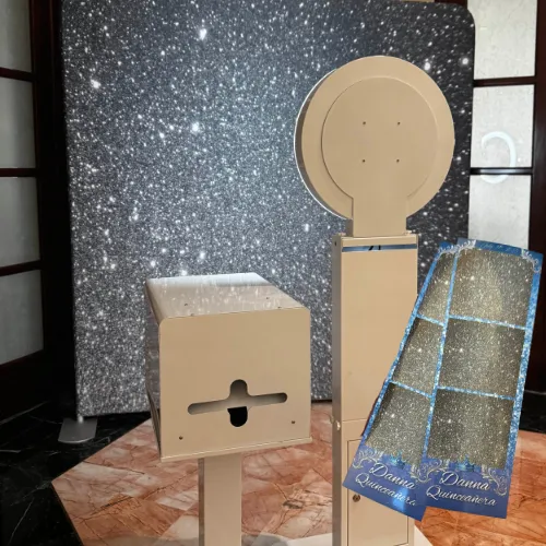 Compact booth setup for intimate private events with matte white casing, teal uplighting and pink neon sign in background, neatly coiled cables and professional touch-screen interface visible, studio-level clarity emphasizing reliability and neat installation.