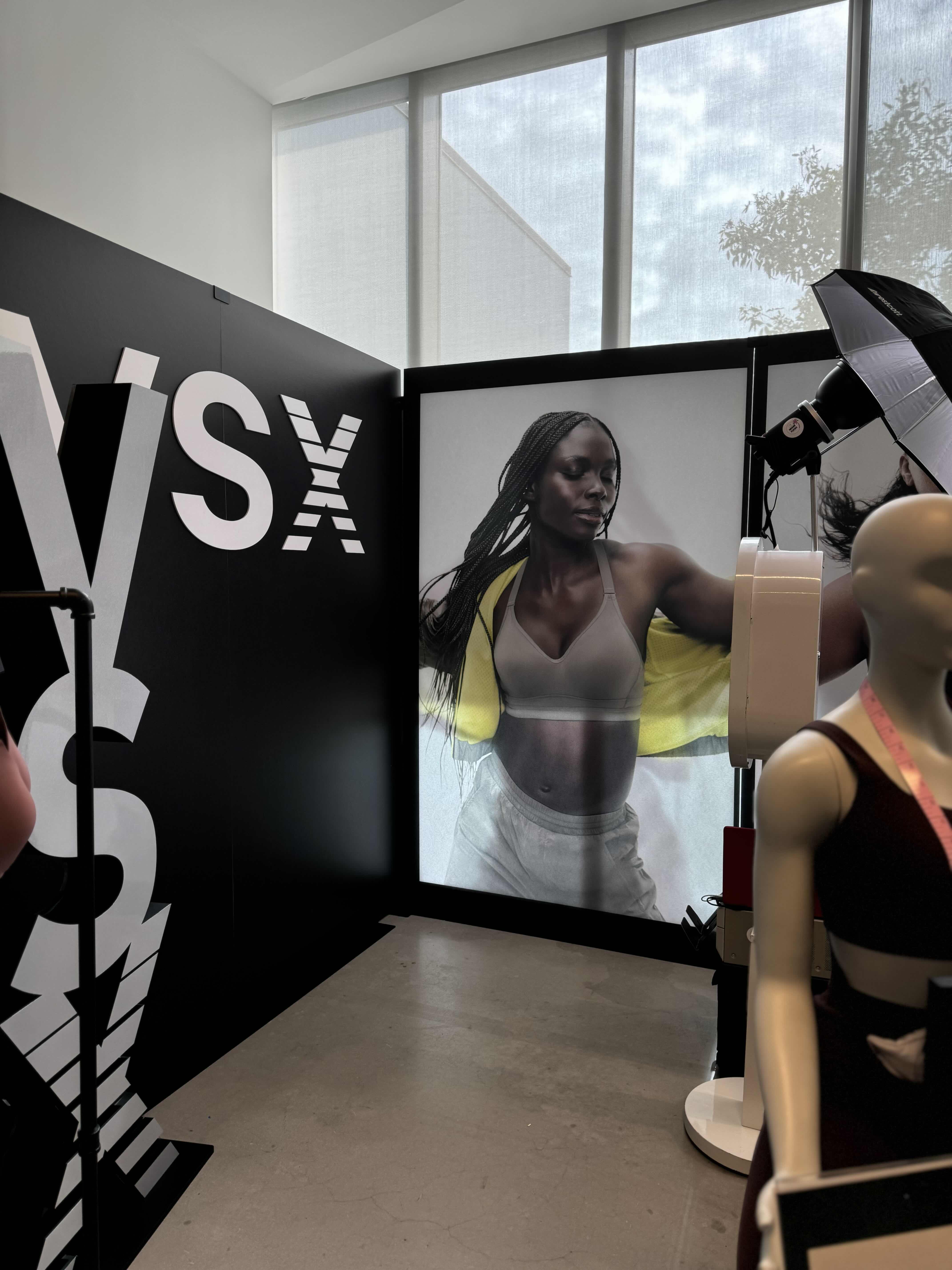 A MiamiFlicks photo booth at a luxury product launch, with a sleek branded backdrop, guests in formal attire interacting with the booth, and a digital screen displaying the brand logo, 3:2 aspect ratio.