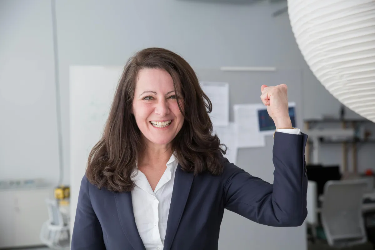 woman putting her fist in the air, smiling