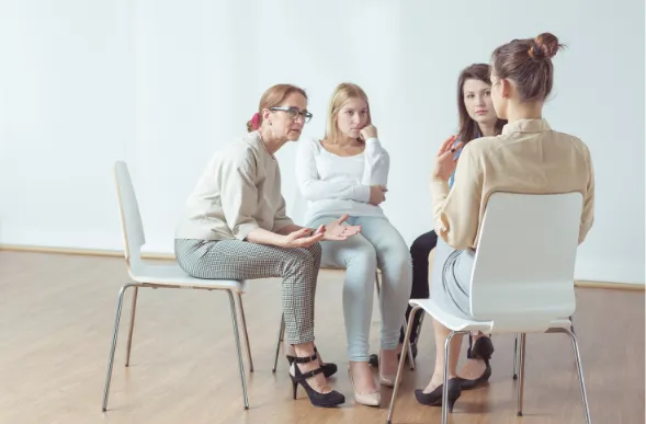 group of women sitting in a circle