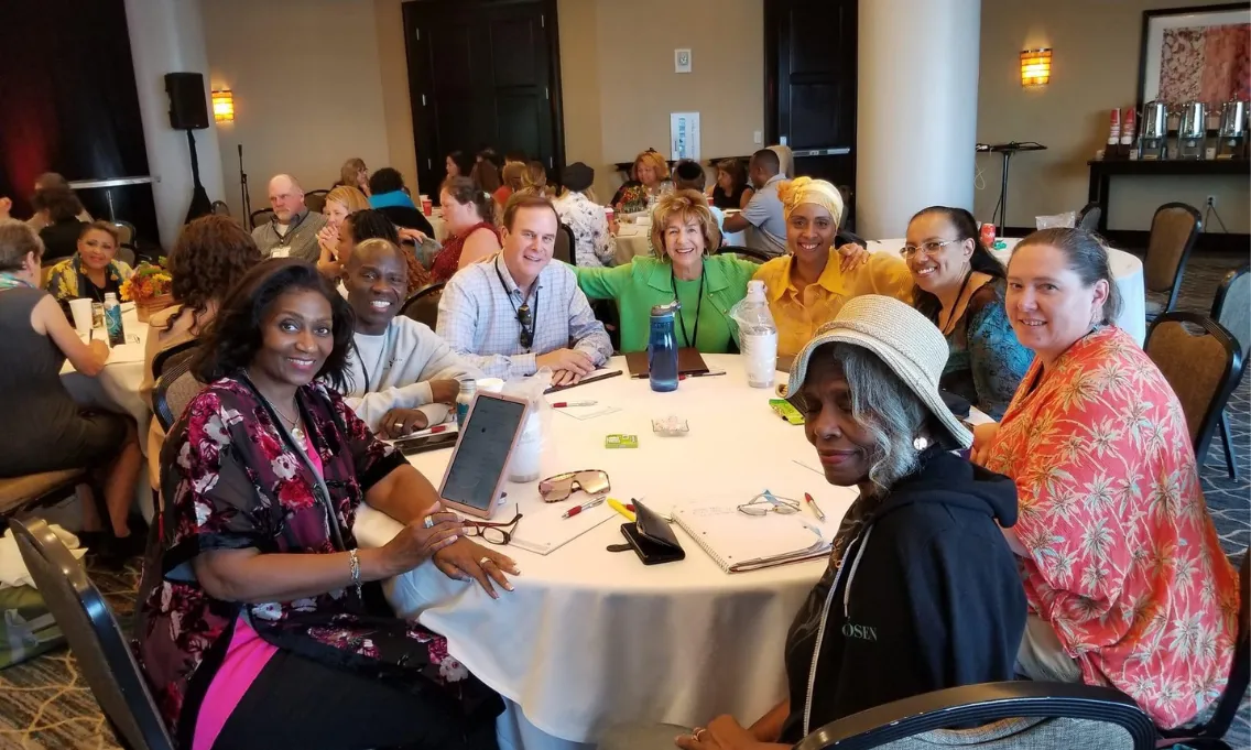 people sitting around a table at a workshop