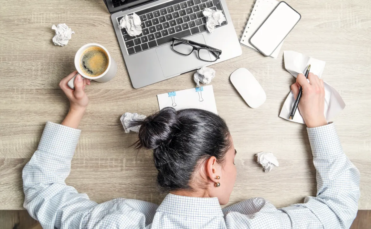 woman at desk exhausted