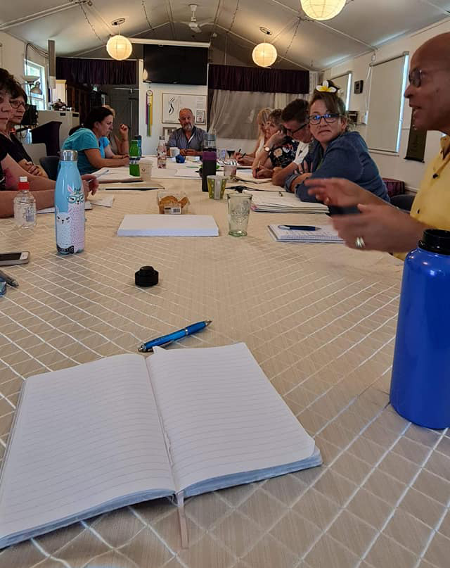 Portrait portfolio image of an evening salon with warm lamplight and close conversation.