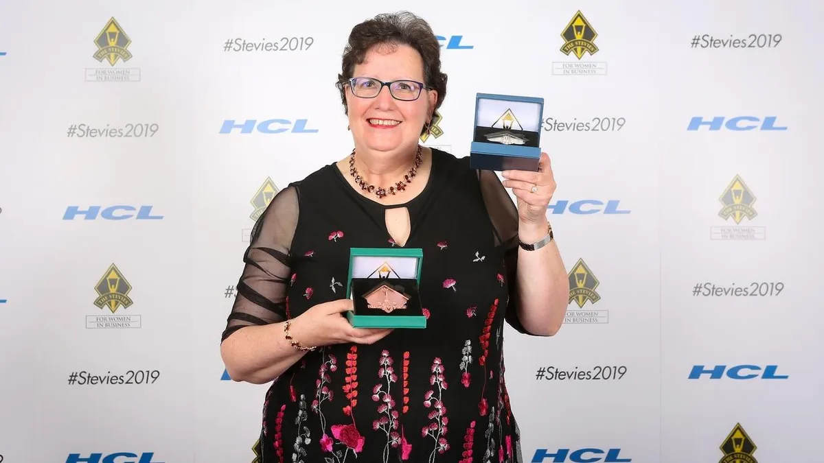 Stevie Awards business recognition event showing entrepreneur at award ceremony celebrating Gold, Silver and Bronze wins in global business excellence awards.