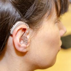 BTE hearing aid in a woman's ear