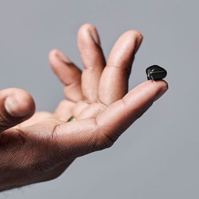 signia insio hearing aid on a fingertip