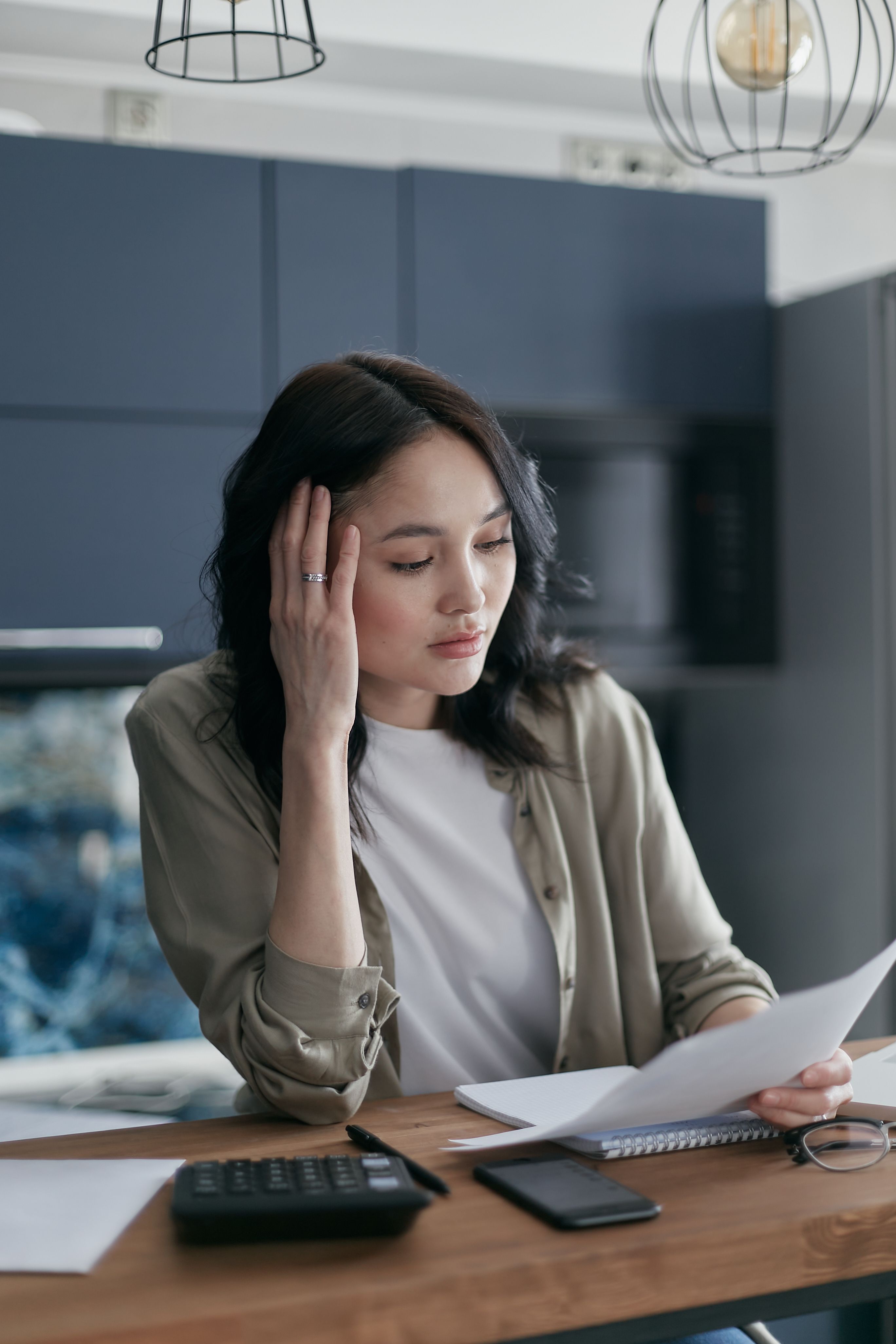 Homeowner reviewing financial and property documents at a table.