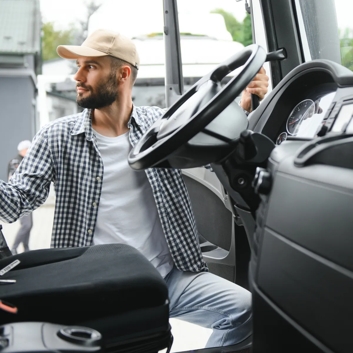 Truck driver standing outside the cab of a commercial vehicle, preparing for a route and representing professionalism in fleet operations and logistics management.