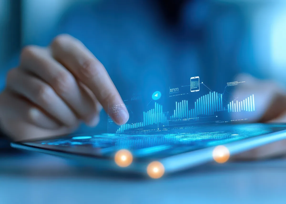 Hand interacting with digital tablet displaying data analytics and graphs, representing adaptive fleet technology and programmable system updates.