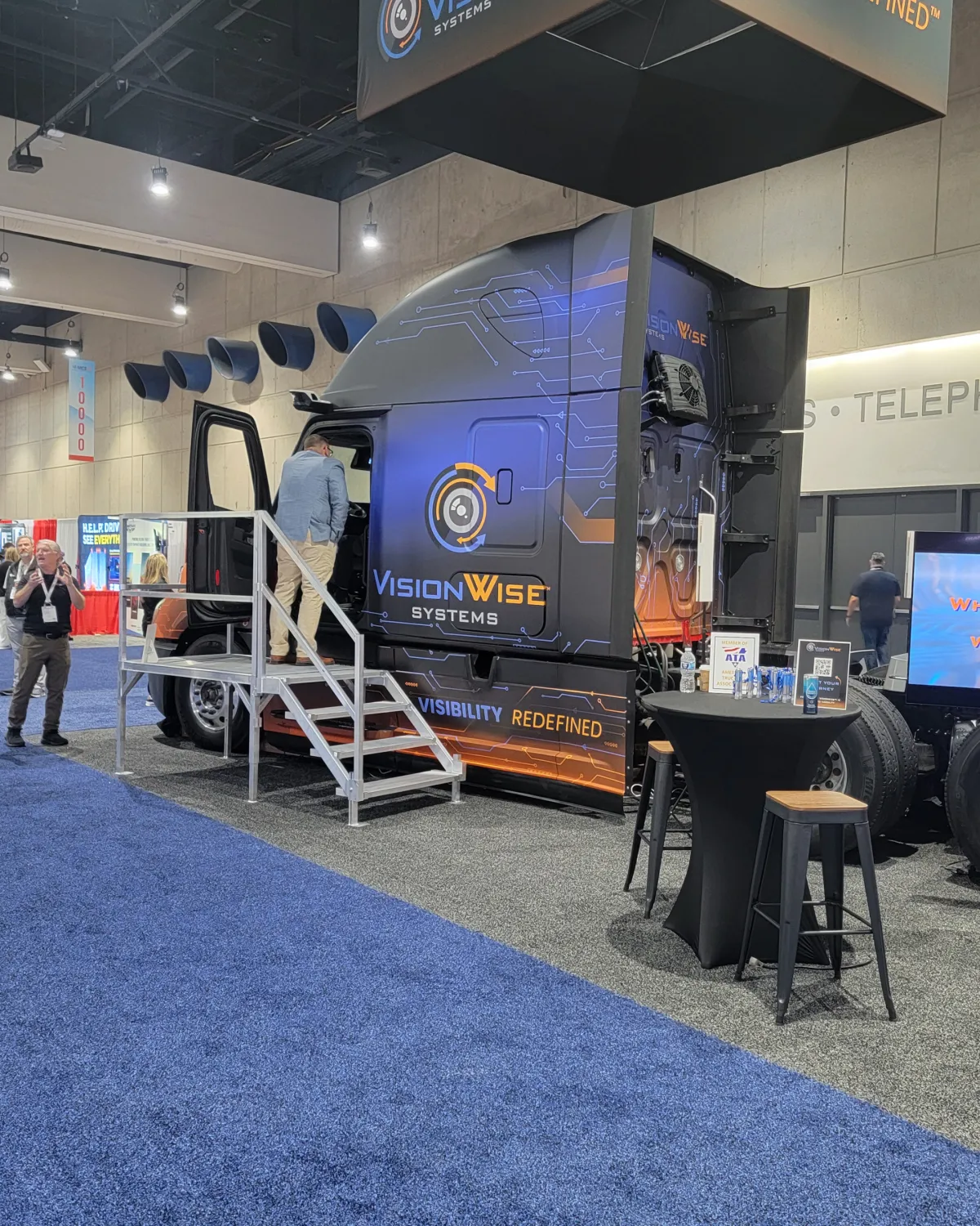 Fleet of modern white semi-trucks parked together, representing large-scale commercial logistics and freight operations