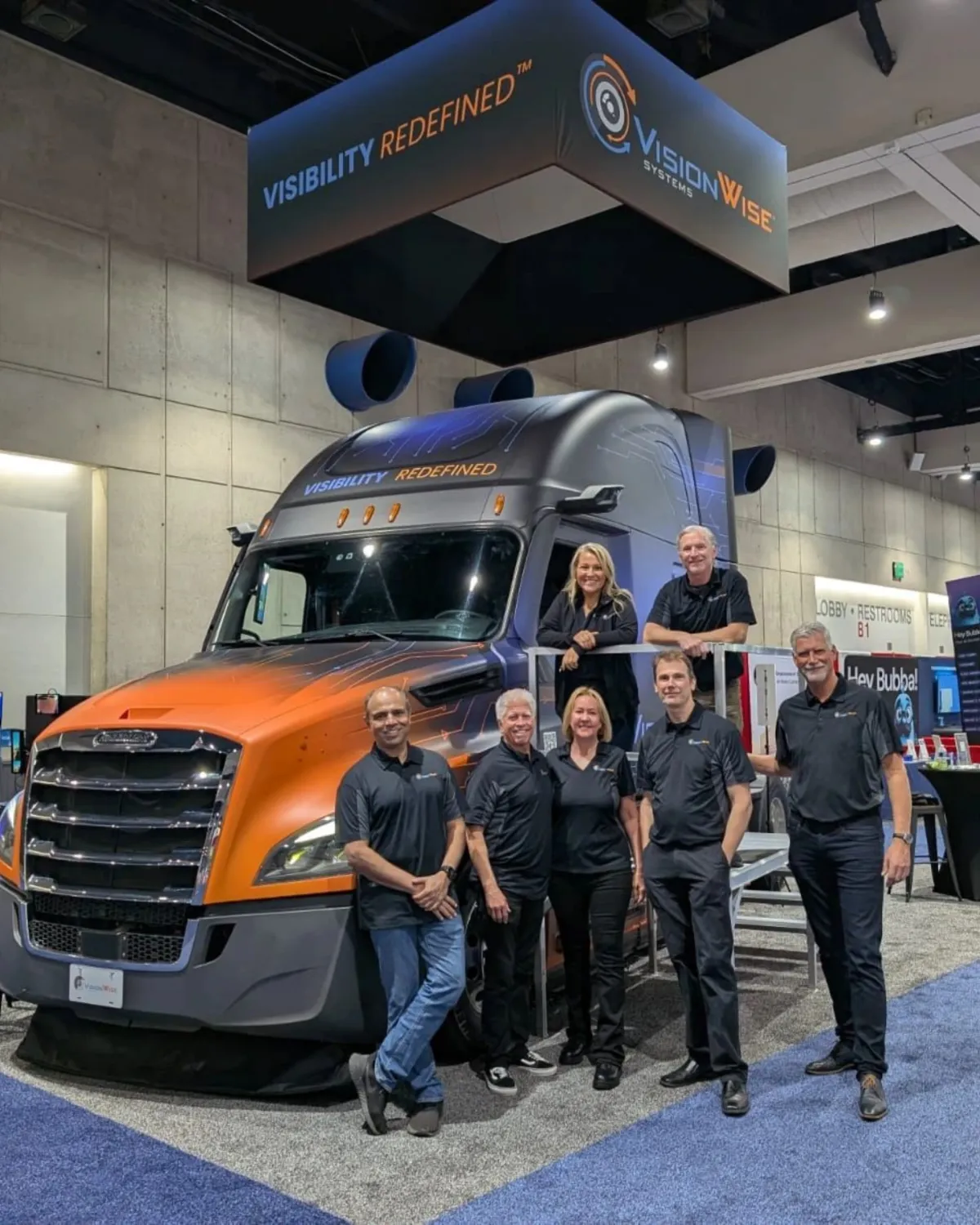 Fleet of modern white semi-trucks parked together, representing large-scale commercial logistics and freight operations