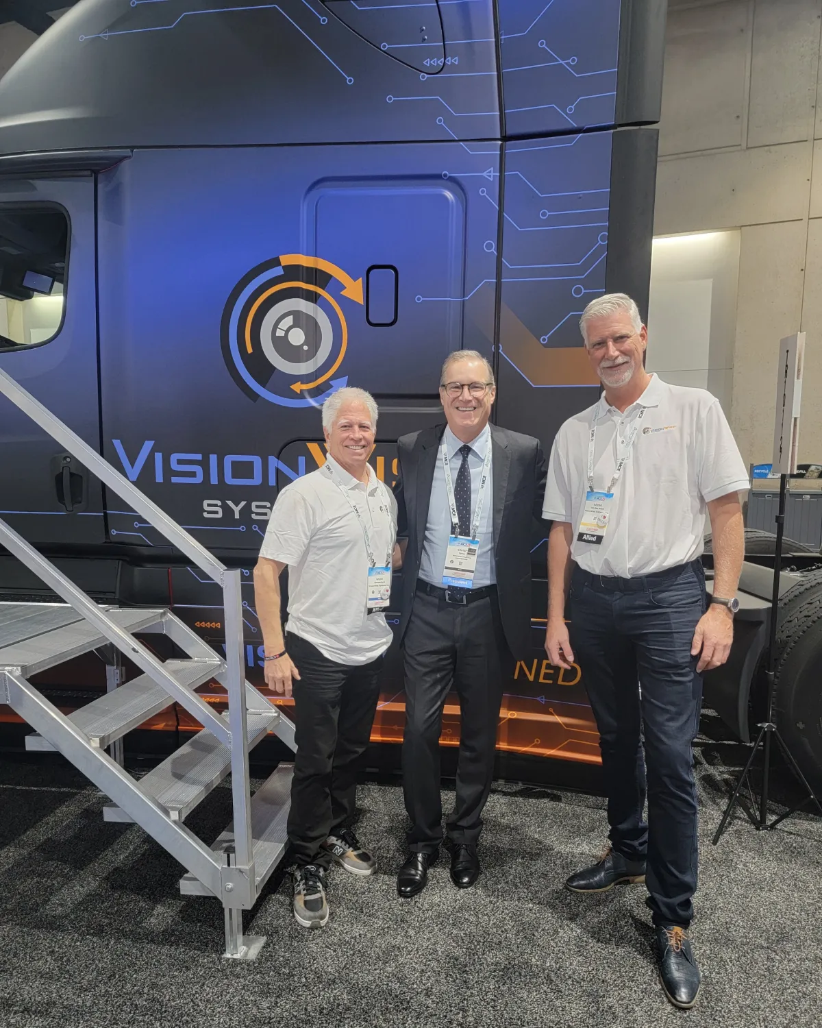 Fleet of modern white semi-trucks parked together, representing large-scale commercial logistics and freight operations