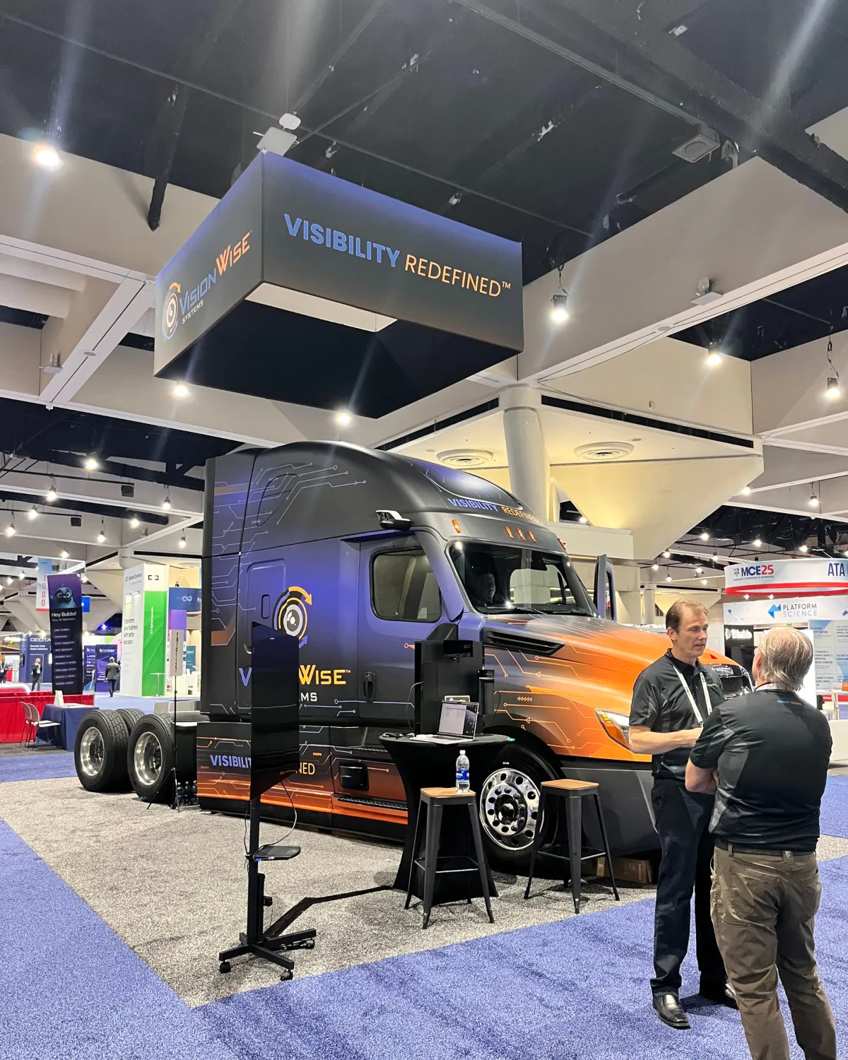 Fleet of modern white semi-trucks parked together, representing large-scale commercial logistics and freight operations