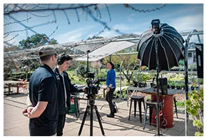 Outdoor interview under a diffusion umbrella in a garden