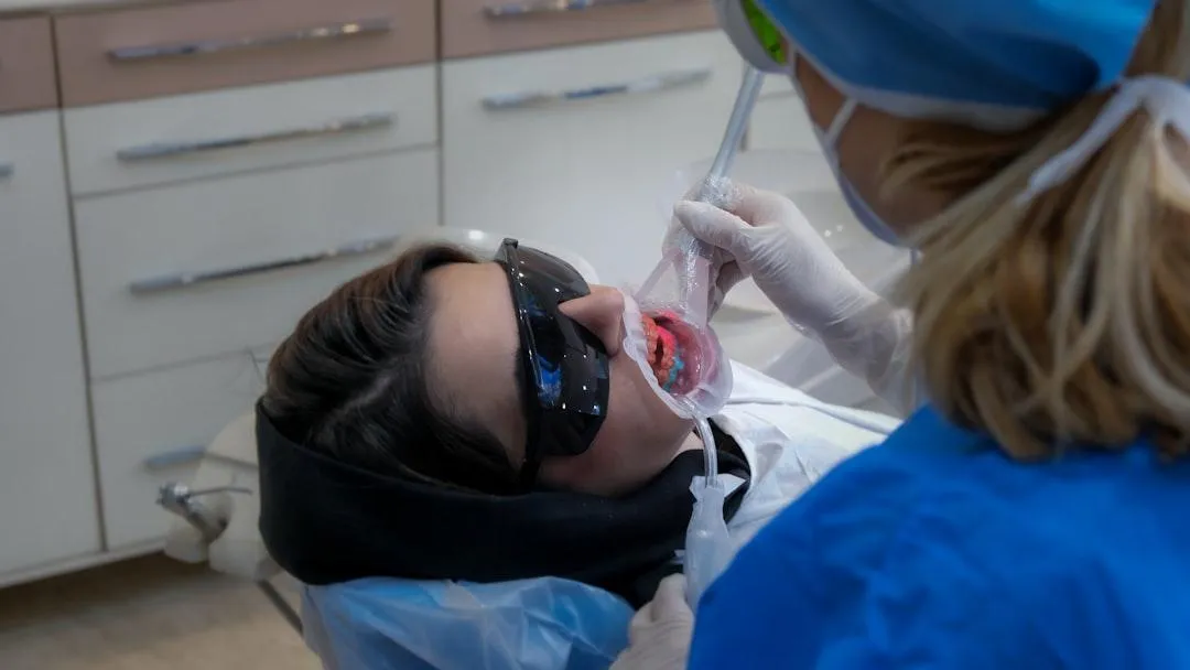 Dentist providing general dentistry treatment to a patient in a dental clinic