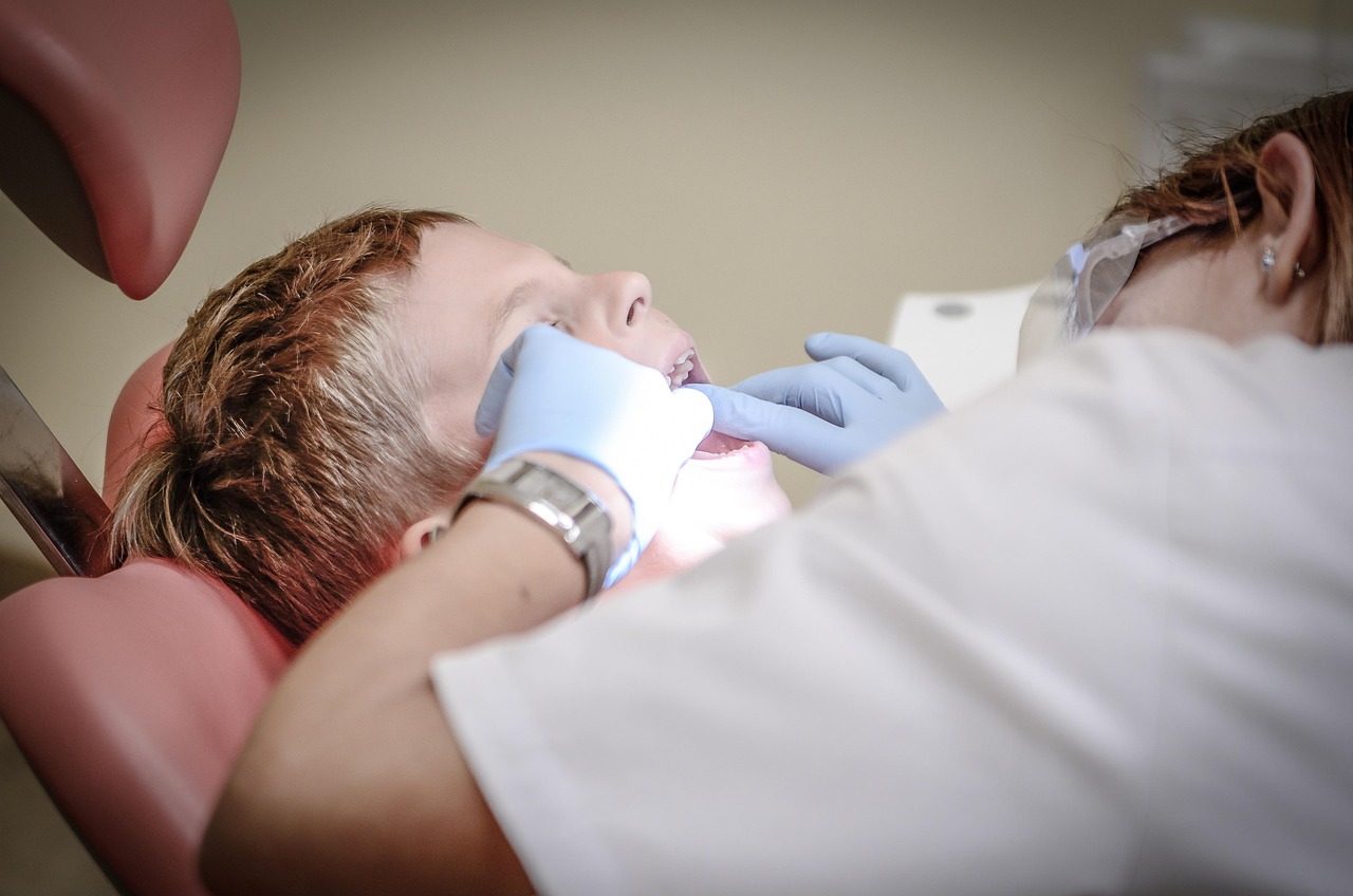 Dentist providing emergency dental care treatment to a patient