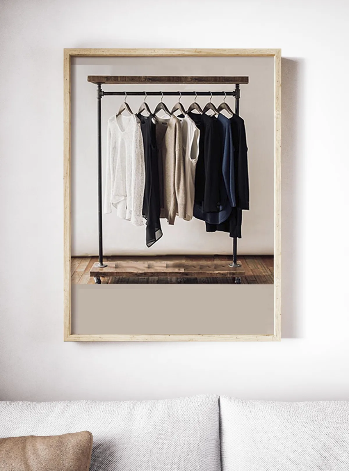 Photo of garments hanging on a ail in a wooden frame 