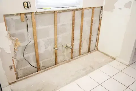 Exposed drywall and framing after water damage – Huntsville Mold Removal Pros.