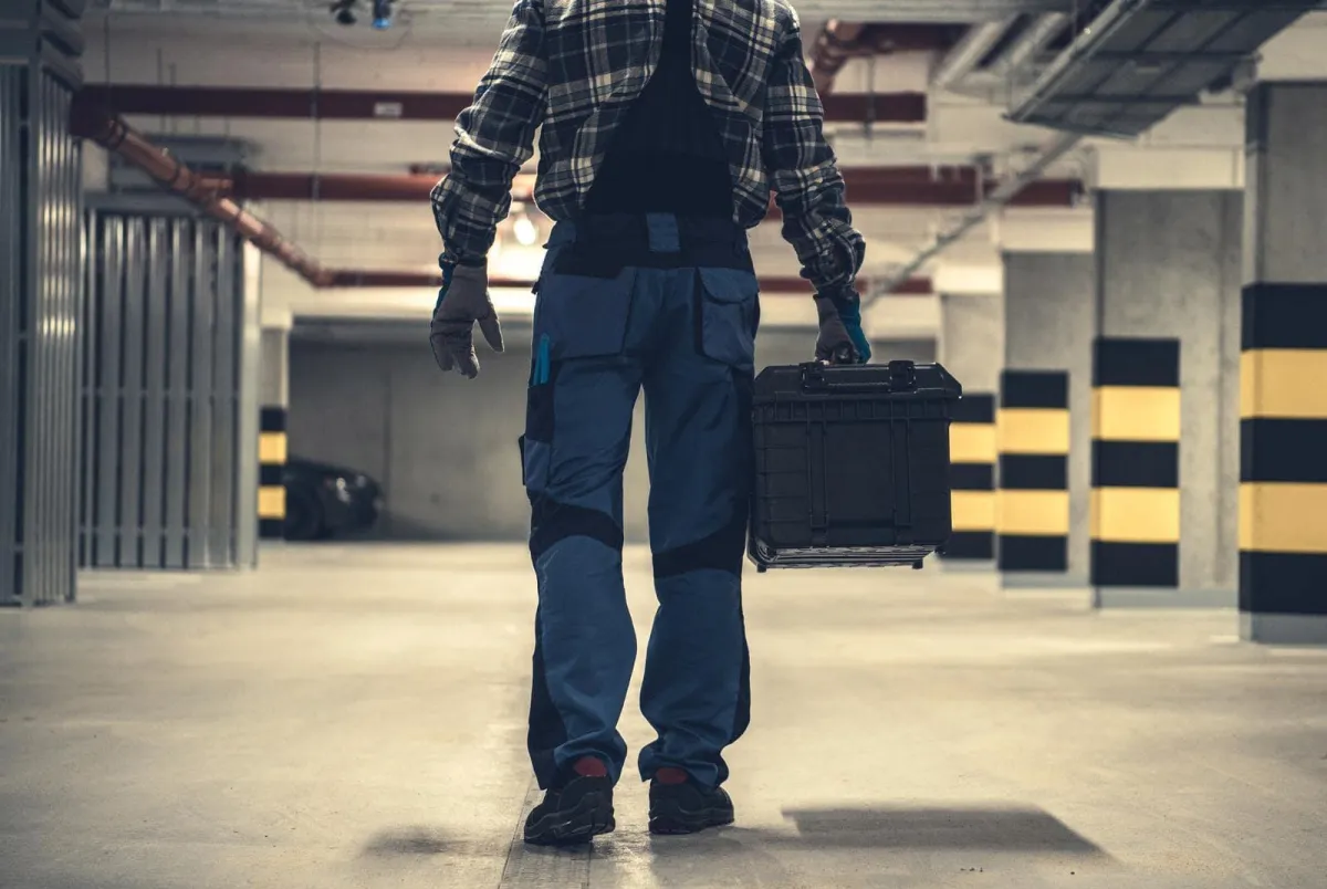 a person carrying a toolbox