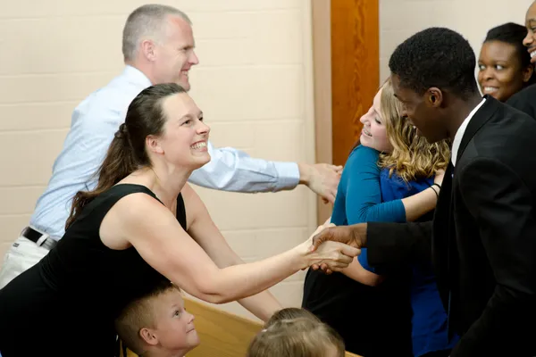 Friendly church members  greeting a new family at The Fountain.