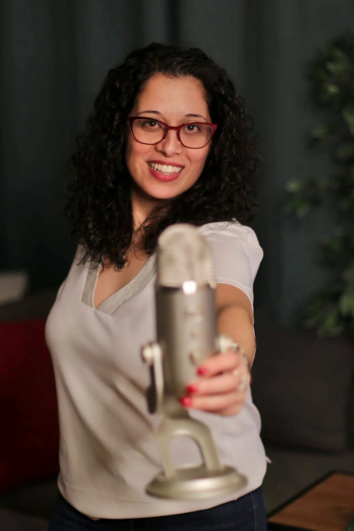 A woman is holding a microphone - Lean Results Pro