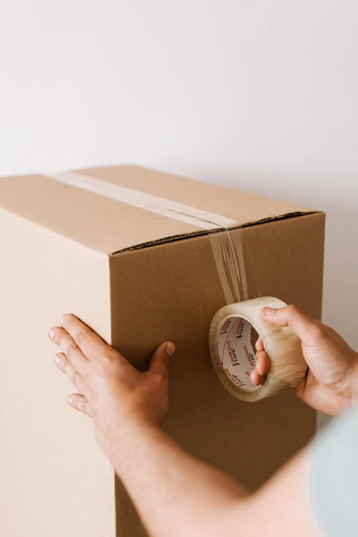 boxes being cellotaped closed by a mover