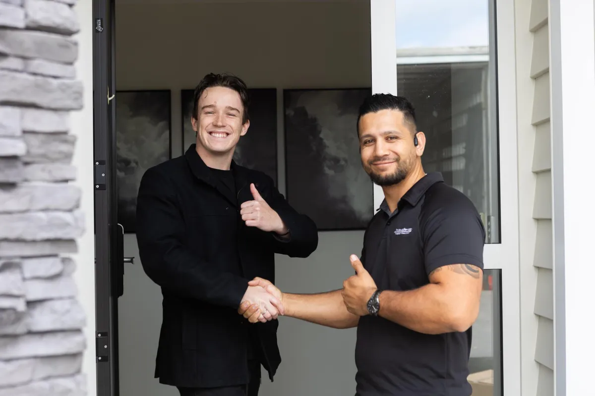 Packing tape dispenser and measuring tape on cardboard boxes, representing moving and relocation services in Auckland.