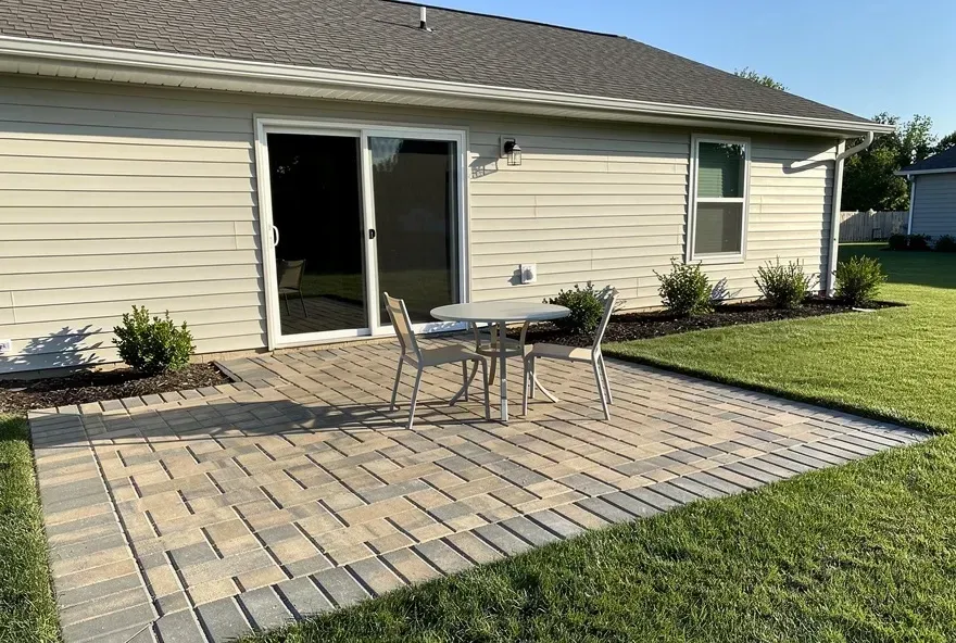Newly installed paver patio attached to the back of a Vineland home with outdoor seating