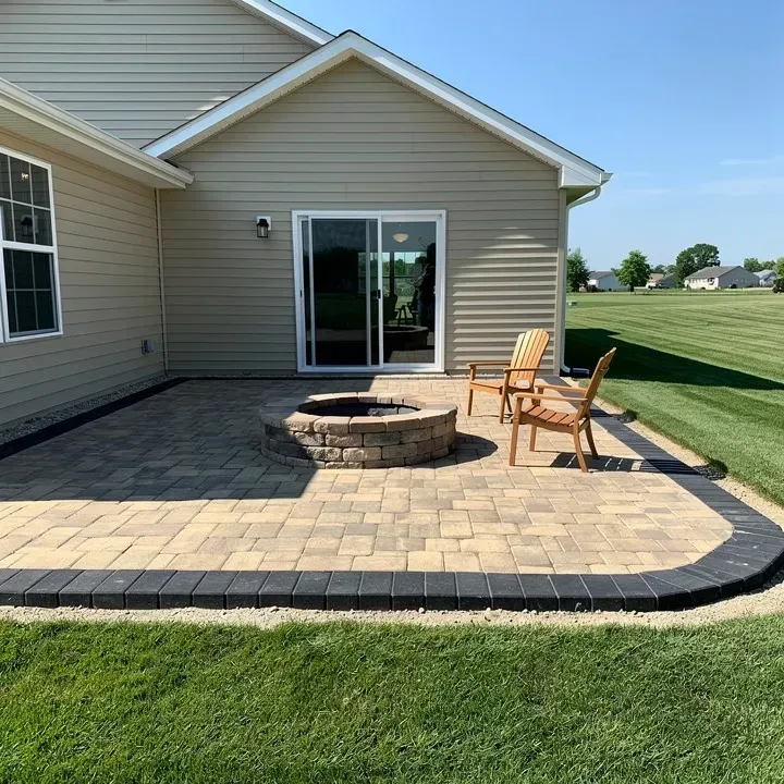 Finished paver patio with a fire pit attached to the back of a Vineland home