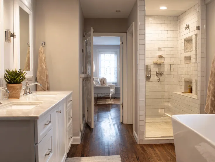 Elegant bathroom renovation featuring marble tile walk in shower soaking tub and custom vanity completed by expert bathroom remodeling specialists