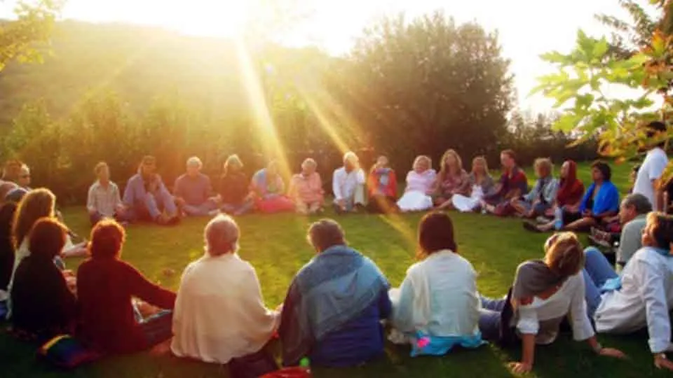 group gathering in circle with light rays coming down