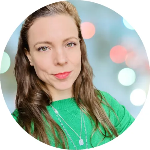 Amy Hrnciar working at a laptop in a bright office, isolated portrait style, used for the about section
