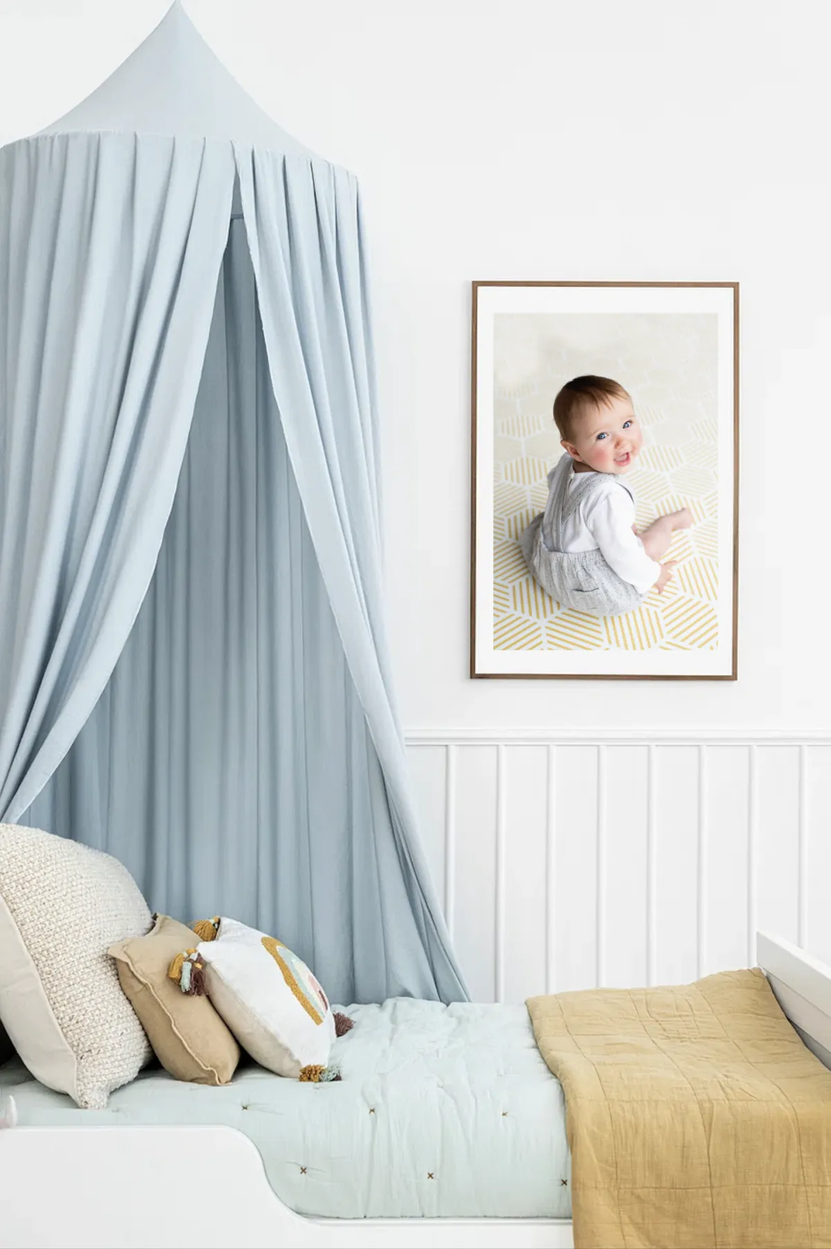 Framed portrait of a baby on the wall of a child's bedroom