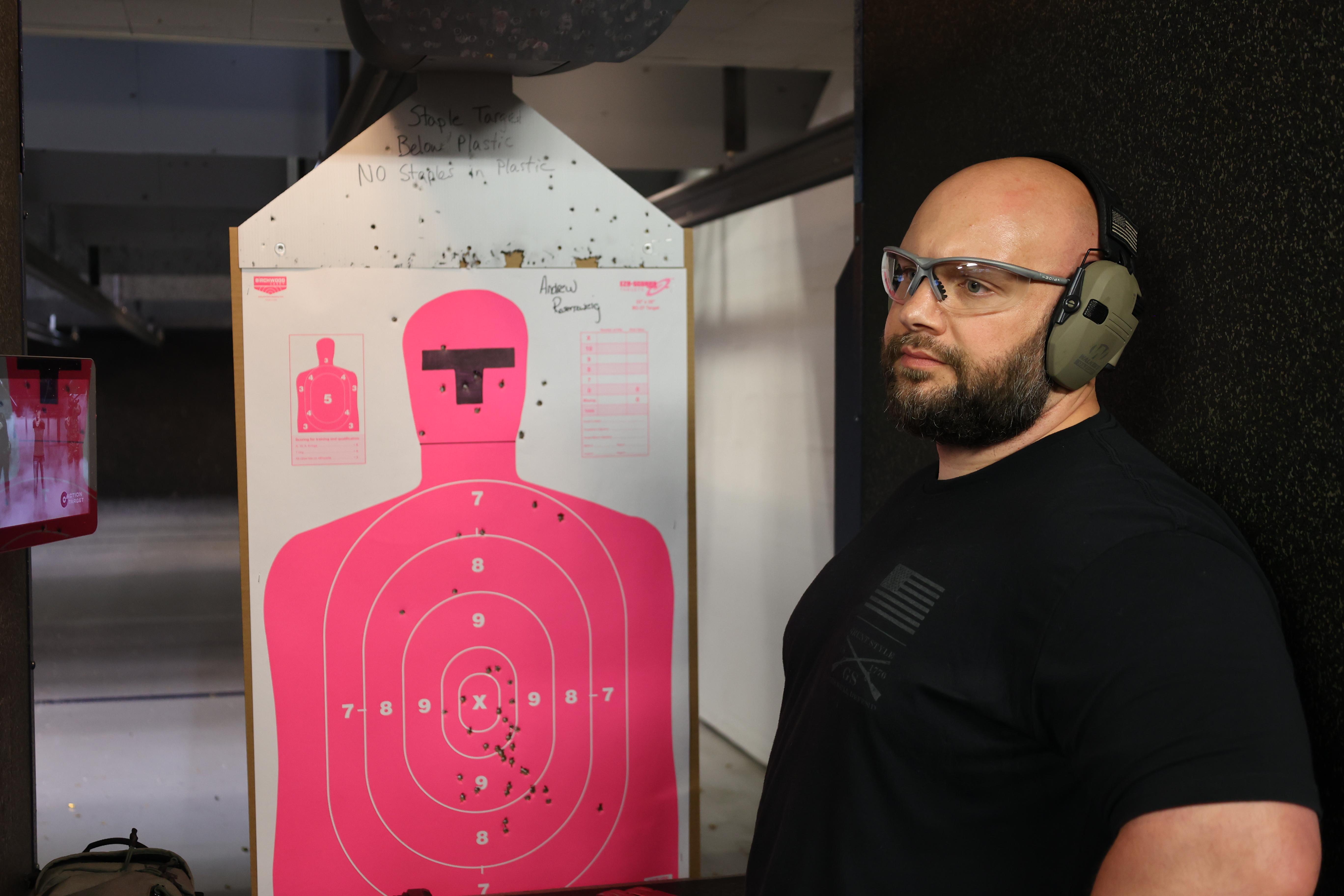 Hikers ascend a snowy mountain path under clear blue sky.
