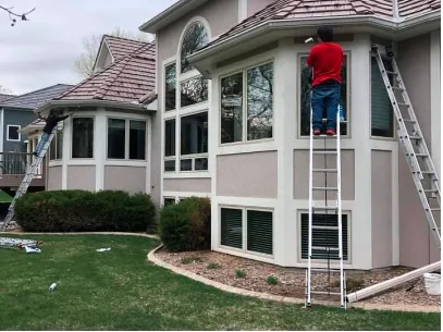 house with worker standing on metal stair