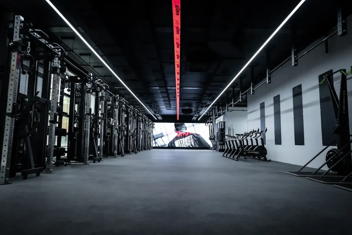 Interior of MARCHON Stratford gym with bold wall branding and strength training equipment