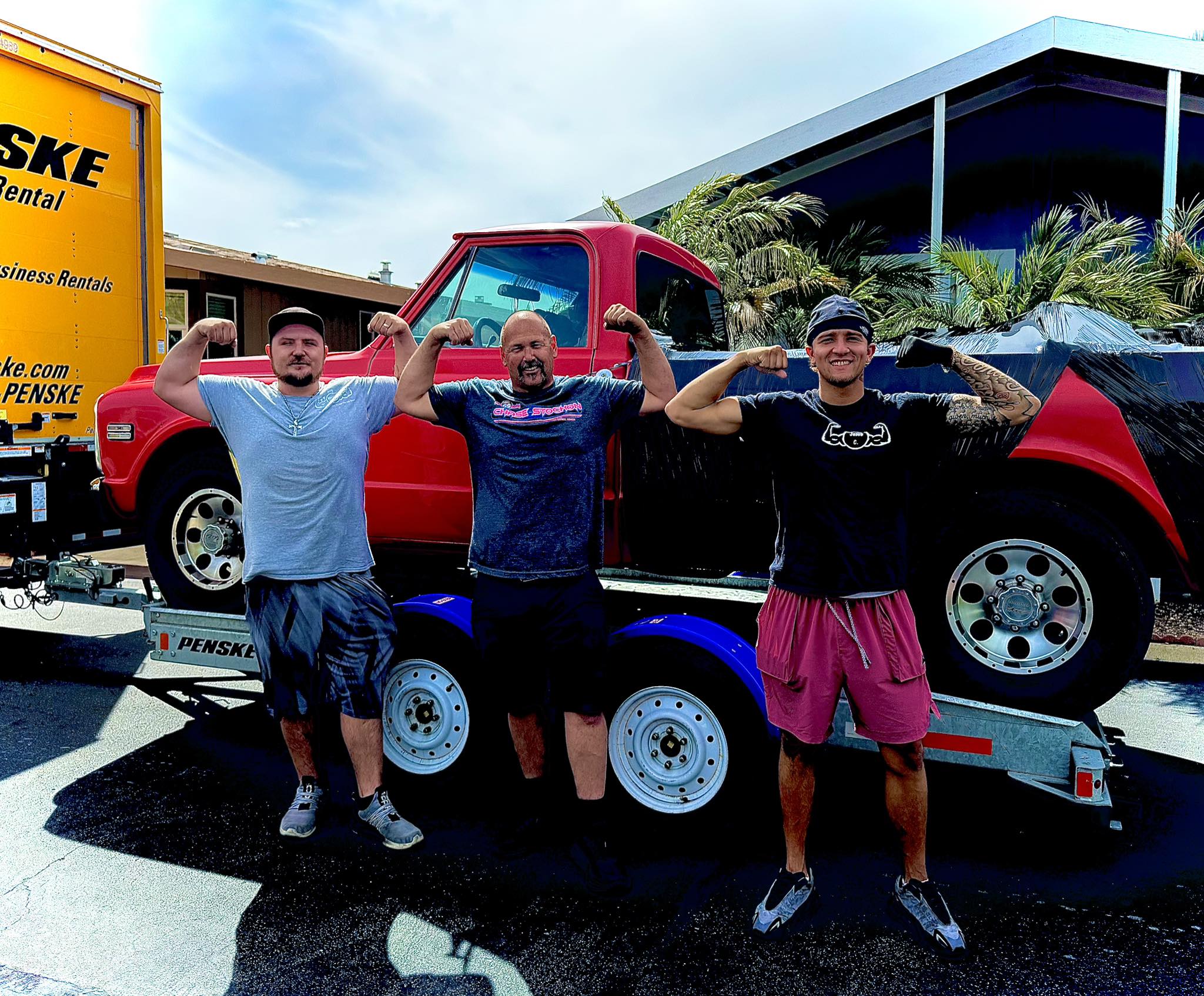 Muscle Movers team photo flexing muscles