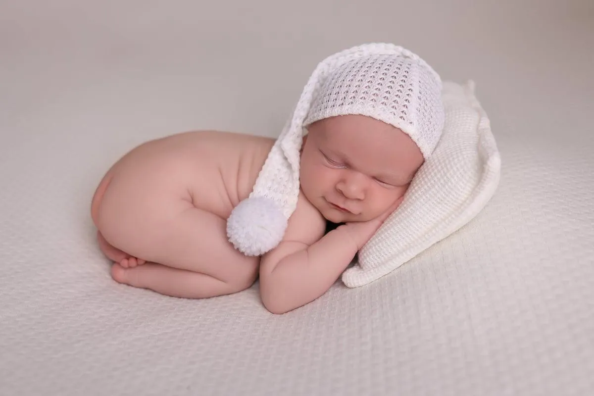 Photo of baby sleeping on its front , taken by Ipswich baby photographer