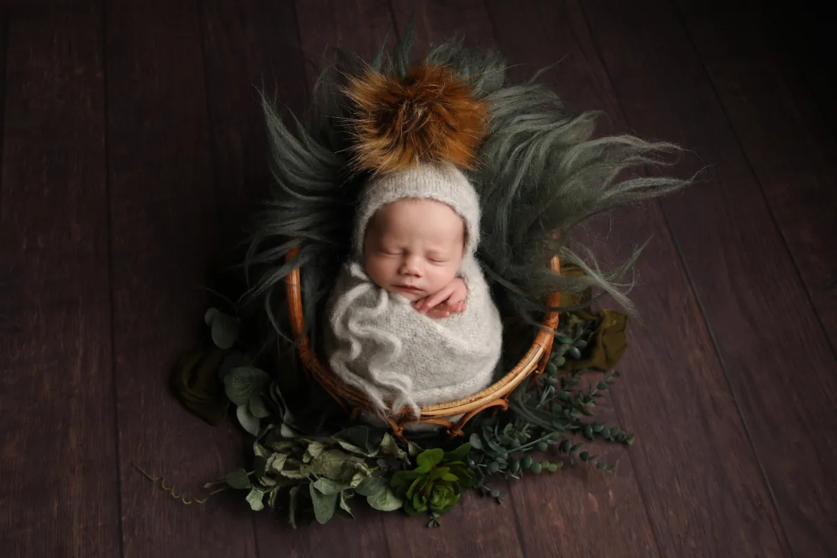 Photo of sleeping baby in basket - Professional baby photos taken by baby art Manchester