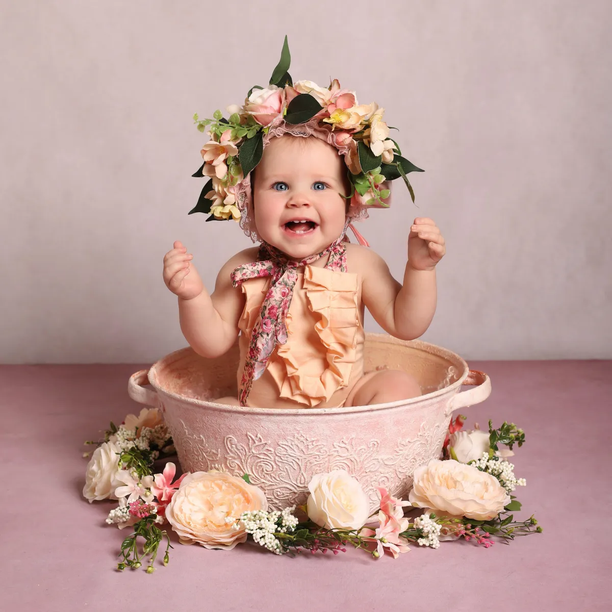 Photo of baby in a basket of flowers, taken by professional photographers in Kent