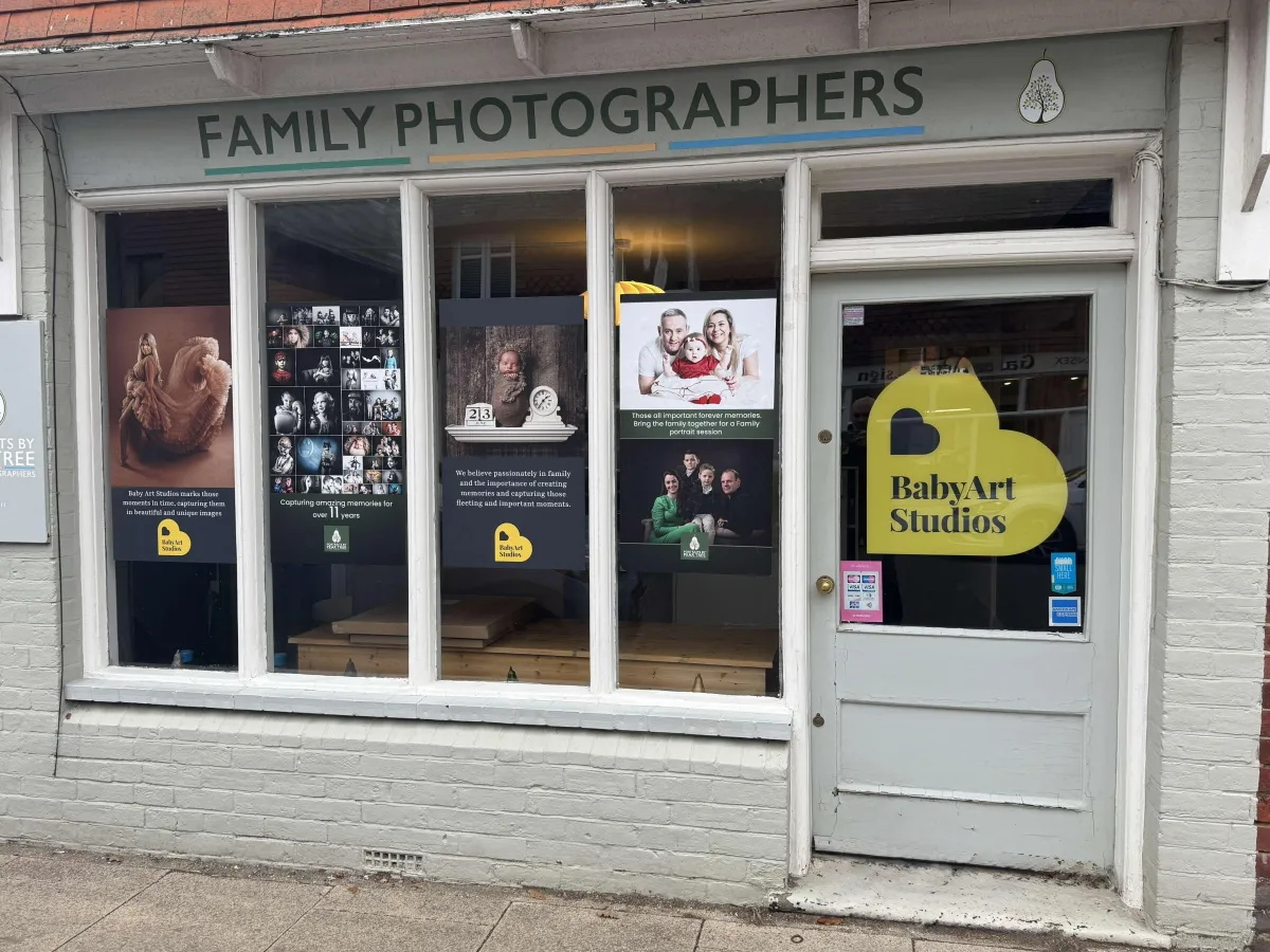 Newborn photography session setup at Baby Art Studios in the UK, showcasing tranquil poses and family moments.