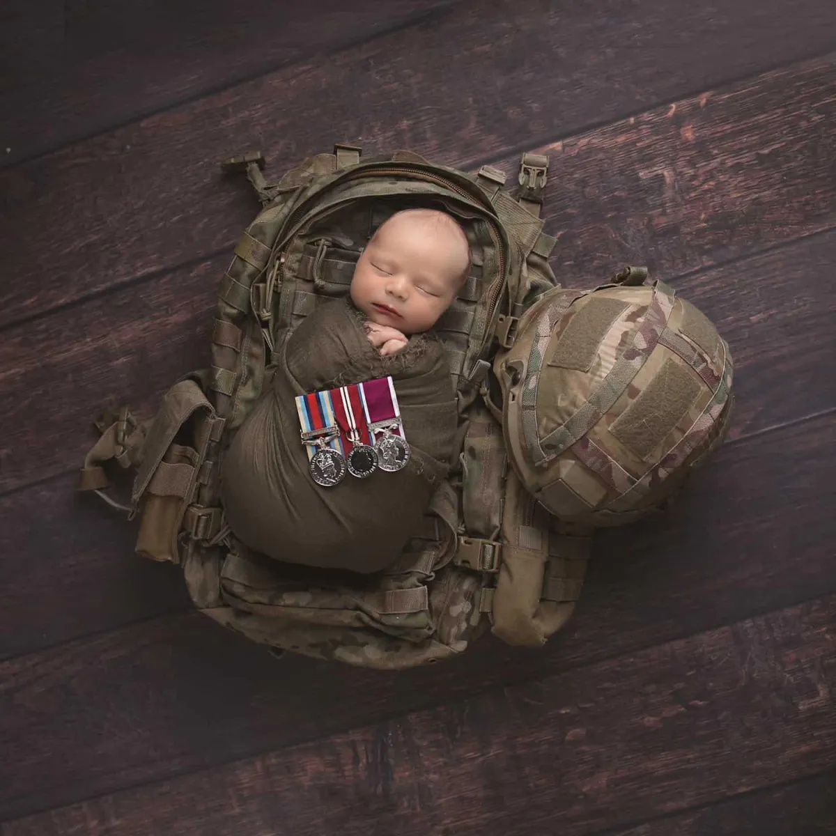 Baby in military backpack for Baby Art Studios Gallery